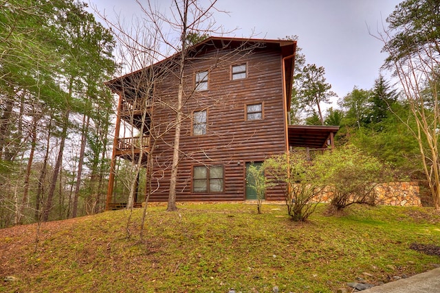 view of side of home with a lawn