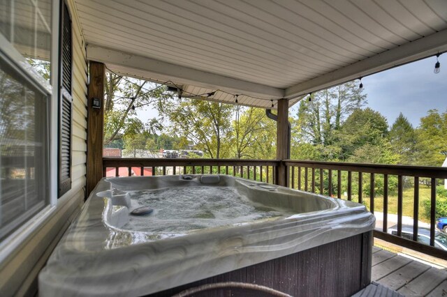 deck featuring a hot tub