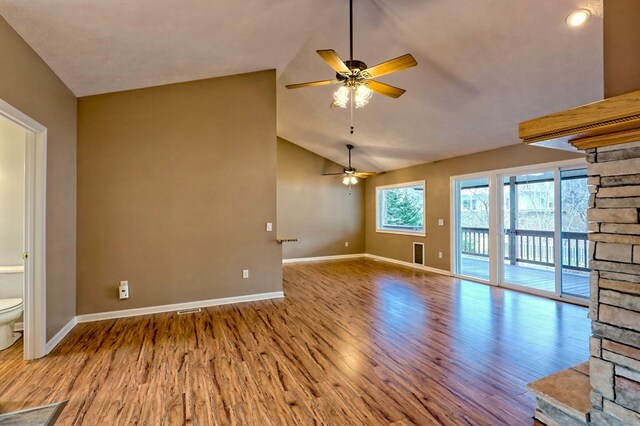 unfurnished living room with ceiling fan, light wood-type flooring, and lofted ceiling