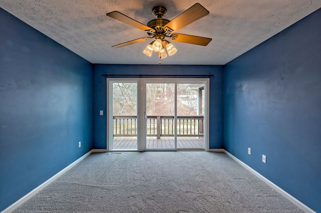 spare room with carpet flooring, ceiling fan, and a textured ceiling