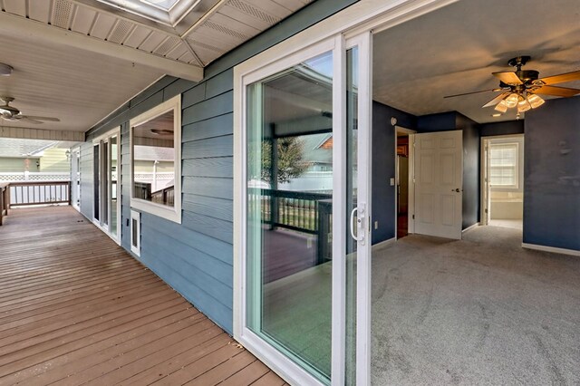 wooden terrace featuring ceiling fan and a porch