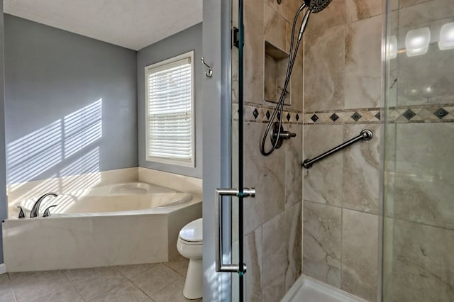 bathroom with toilet, tile patterned floors, and separate shower and tub