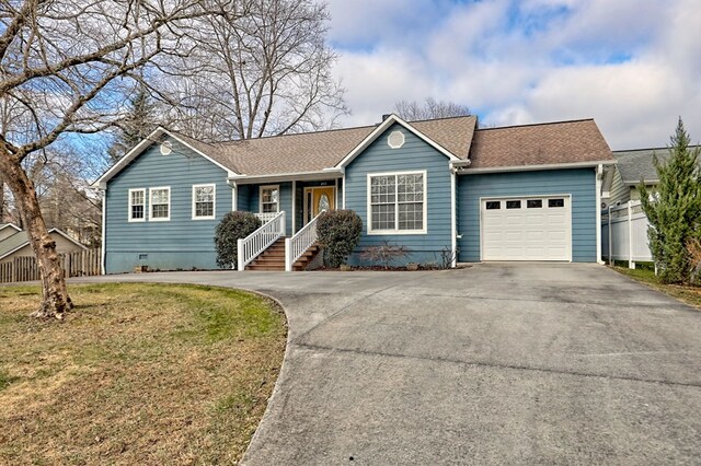 ranch-style house with a porch, a front yard, and a garage