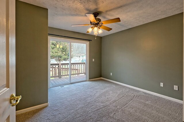 carpeted spare room with ceiling fan and a textured ceiling