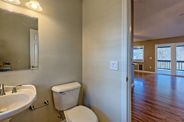 bathroom with hardwood / wood-style flooring, sink, and toilet