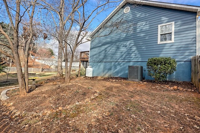 view of home's exterior featuring cooling unit and a deck