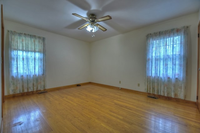 spare room with ceiling fan and wood-type flooring