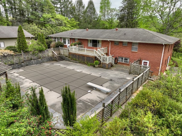 back of house with a pool side deck and a patio area