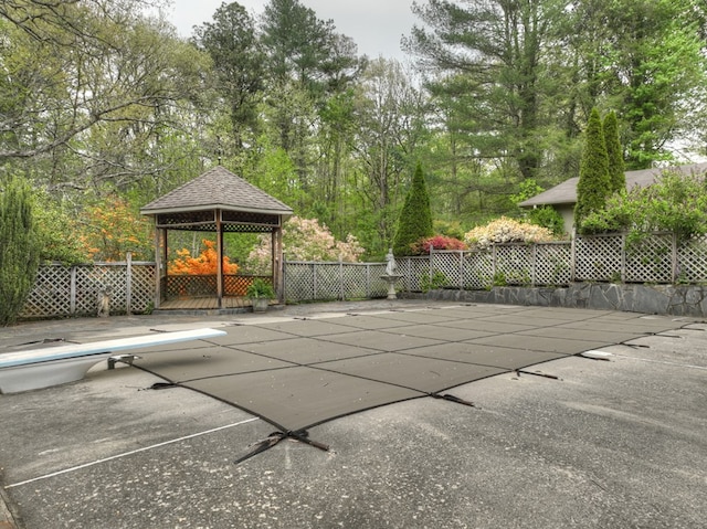 view of pool with a gazebo and a diving board