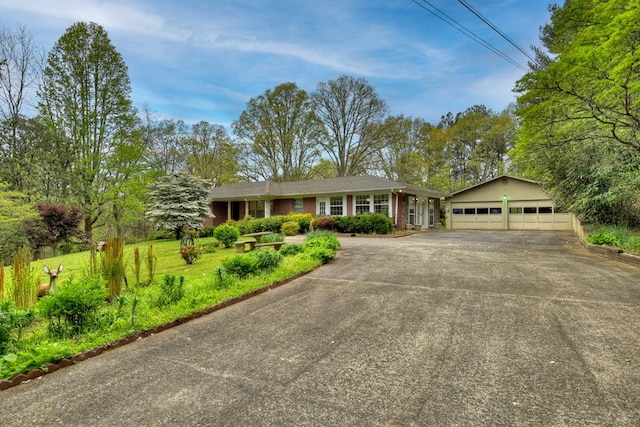 single story home with a front lawn and a garage