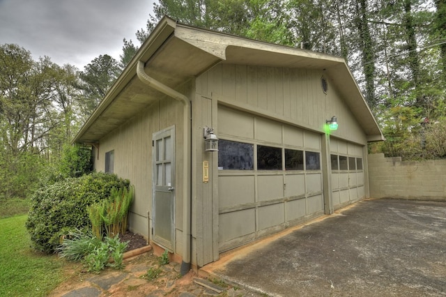 view of side of property with a garage and an outbuilding