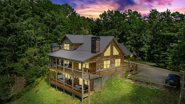 view of back house at dusk