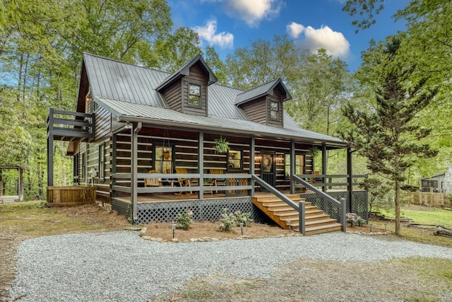 view of front of home with metal roof and a porch