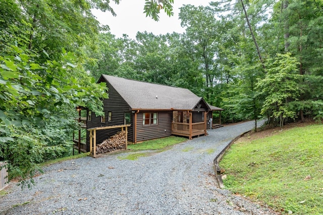 exterior space featuring a wooden deck and a lawn