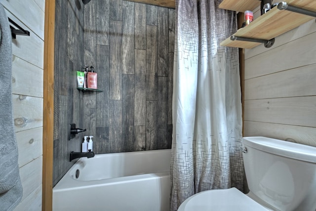 bathroom featuring shower / bath combination with curtain, toilet, and wooden walls