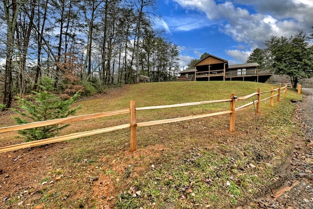 view of yard with a rural view and a deck