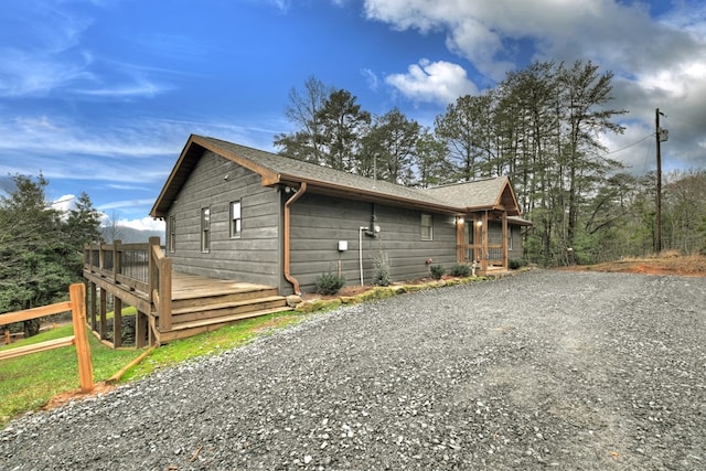 view of side of property with a wooden deck