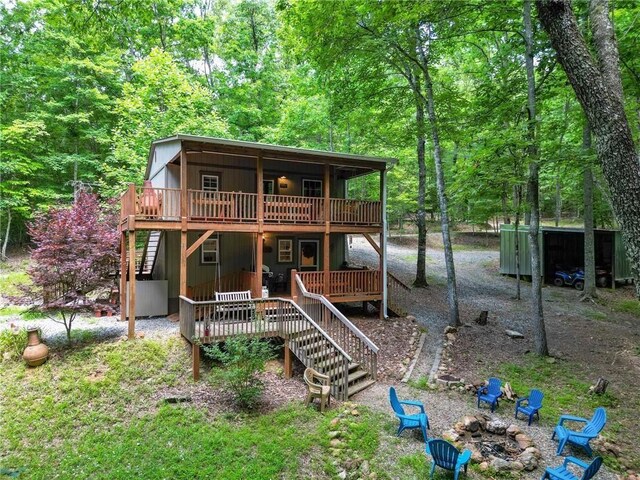 rear view of property featuring a wooden deck