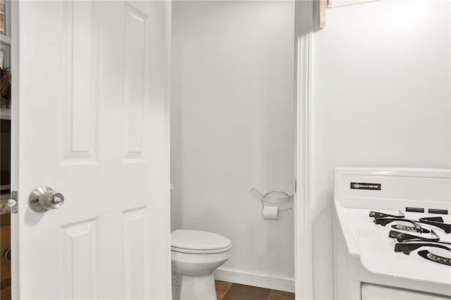 bathroom with toilet and tile patterned floors