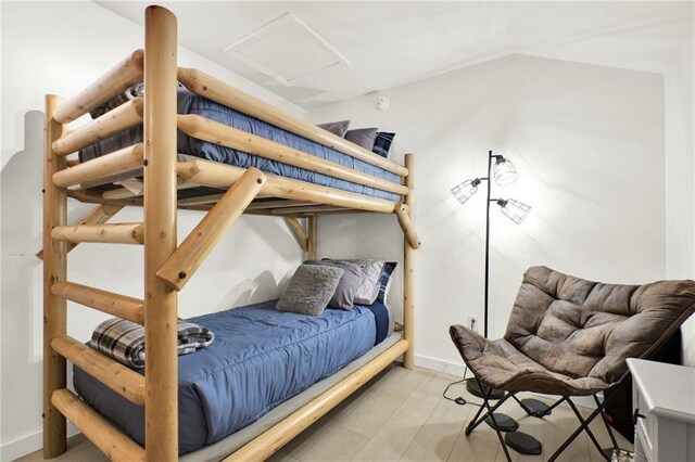 bedroom with light hardwood / wood-style flooring and vaulted ceiling