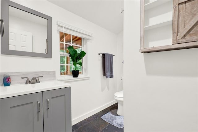 bathroom with vanity, tile patterned flooring, and toilet