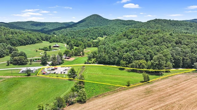 birds eye view of property featuring a rural view, a mountain view, and a view of trees