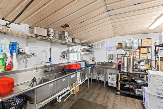 kitchen with wood finished floors and vaulted ceiling