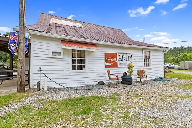 back of house with metal roof