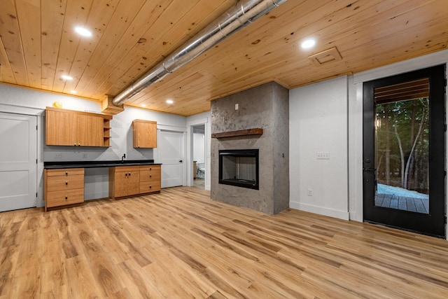 kitchen with wooden ceiling, a fireplace, and light wood-type flooring