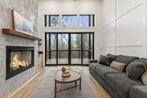 living room with a towering ceiling and light hardwood / wood-style flooring