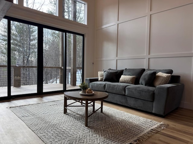 living room featuring a high ceiling and wood-type flooring