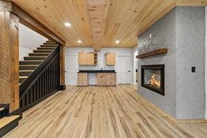 unfurnished living room featuring wooden ceiling and light hardwood / wood-style floors