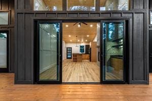 doorway to outside with a towering ceiling and light hardwood / wood-style flooring