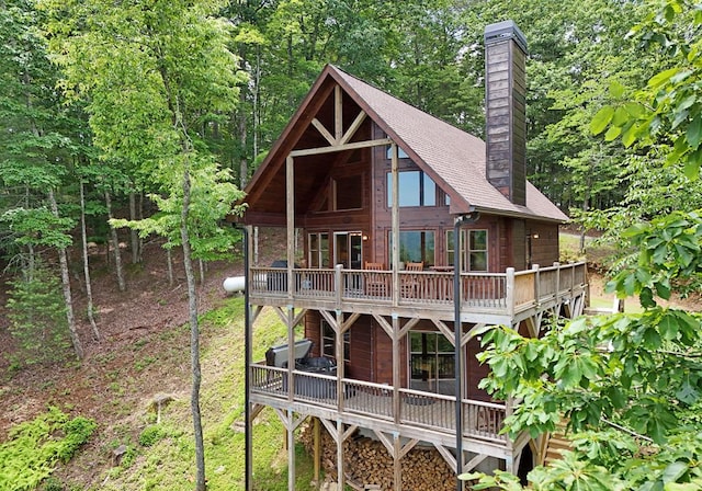 73 Rosiey Ln, Blue Ridge, GA 30513 - back of house featuring a chimney, a deck, and roof with shingles