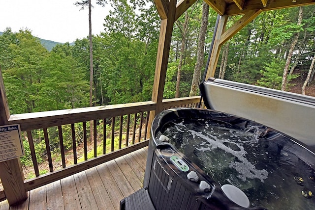 73 Rosiey Ln, Blue Ridge, GA 30513 - wooden deck with a hot tub and a wooded view