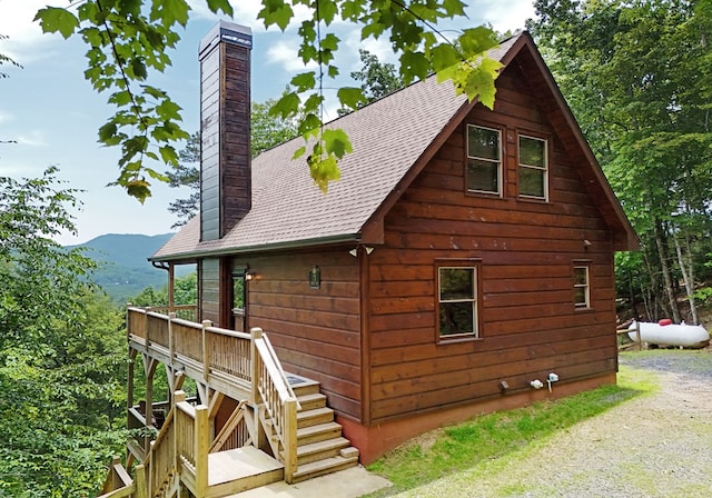73 Rosiey Ln, Blue Ridge, GA 30513 - view of property exterior featuring a shingled roof, a chimney, a mountain view, and stairs