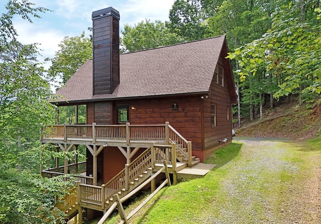 73 Rosiey Ln, Blue Ridge, GA 30513 - rear view of house featuring stairs, a chimney, roof with shingles, and driveway