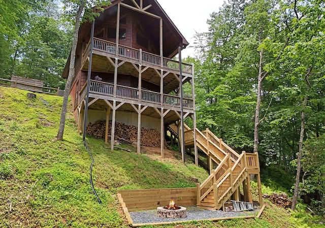 73 Rosiey Ln, Blue Ridge, GA 30513 - back of property with an outdoor fire pit, stairway, and a deck