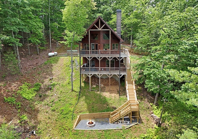 73 Rosiey Ln, Blue Ridge, GA 30513 - rear view of property with stairs, a deck, a chimney, and an outdoor fire pit