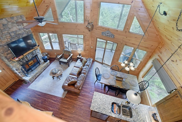 73 Rosiey Ln, Blue Ridge, GA 30513 - living room featuring high vaulted ceiling, healthy amount of natural light, wood walls, a fireplace, and wood finished floors