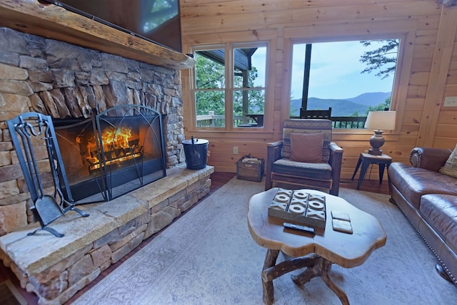 73 Rosiey Ln, Blue Ridge, GA 30513 - living area with a stone fireplace, wood walls, and a mountain view