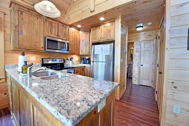 73 Rosiey Ln, Blue Ridge, GA 30513 - kitchen with appliances with stainless steel finishes, dark wood finished floors, brown cabinets, light stone counters, and a peninsula
