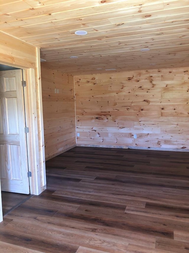 additional living space featuring wood ceiling, dark hardwood / wood-style flooring, and wood walls