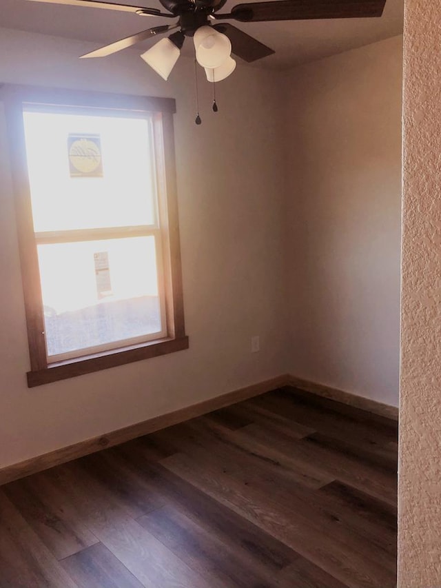 spare room featuring dark hardwood / wood-style floors and ceiling fan