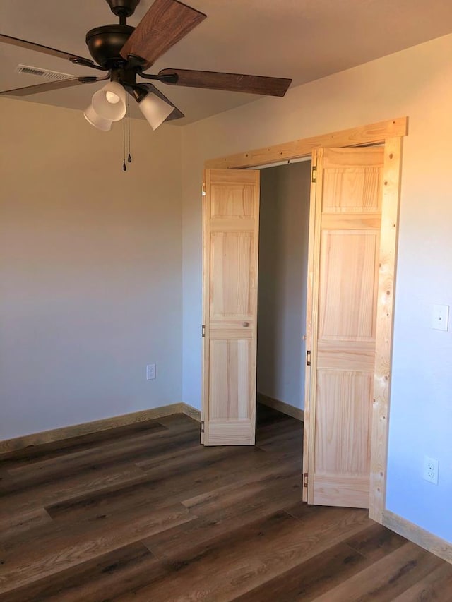 unfurnished bedroom with dark wood-type flooring and ceiling fan