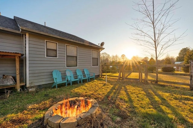 exterior space featuring a lawn and an outdoor fire pit