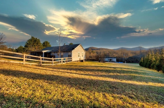 view of horse barn featuring a mountain view and a rural view