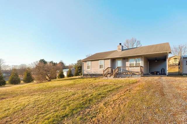 rear view of house featuring a yard