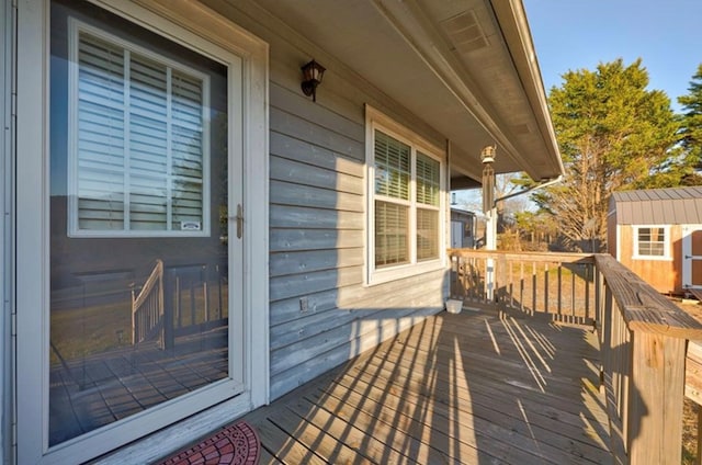 wooden terrace with a shed