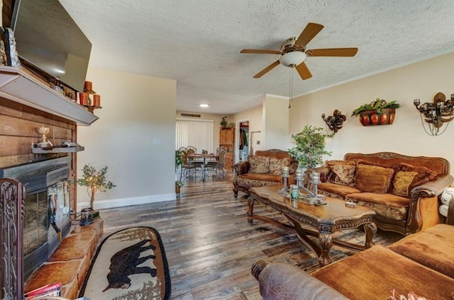 living room with ceiling fan, crown molding, dark wood-type flooring, and a textured ceiling